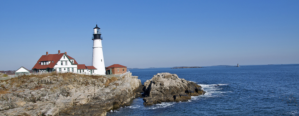 A lighthouse on a rocky shore in Northeastern U.S.